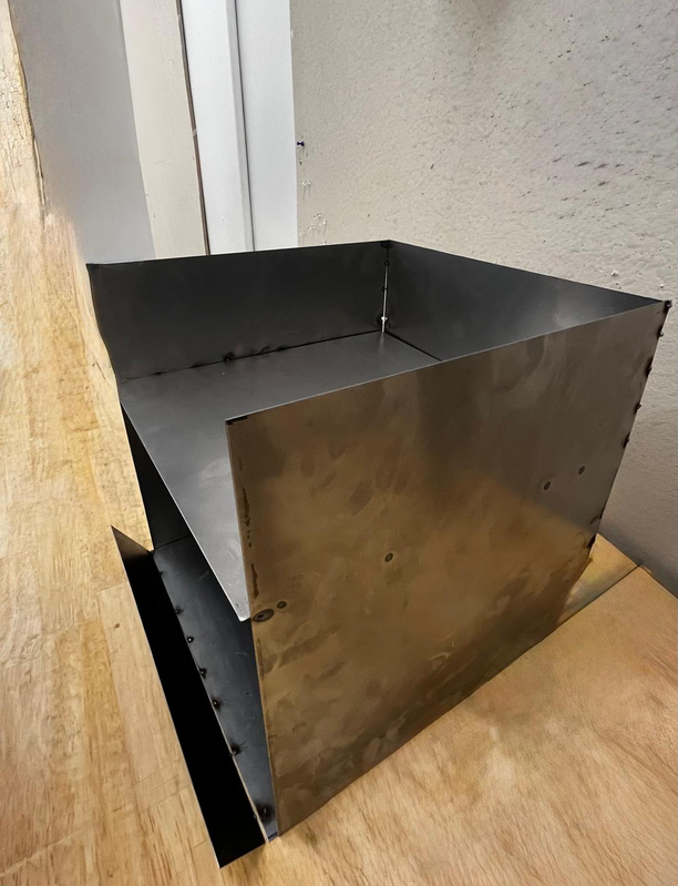 City Chula — a welded sheet-metal stove in the workshop
