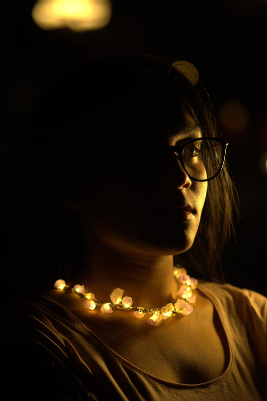 A glowing rose-quartz necklace worn in the dark